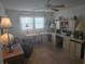Bright home office featuring a built-in desk, comfortable seating, and plenty of natural light from the large window at 5705 80Th N St # 303, St Petersburg, FL 33709