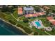 Beautiful aerial view of a bayfront community including a swimming pool and lush green landscaping at 6158 Palma Del Mar S Blvd # 306, St Petersburg, FL 33715