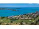Community aerial view with a golf course, ocean access, and condo buildings with terracotta roofs at 6158 Palma Del Mar S Blvd # 306, St Petersburg, FL 33715