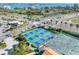Aerial of a well-maintained community pickleball and tennis courts, surrounded by lush greenery and paved parking at 6158 Palma Del Mar S Blvd # 306, St Petersburg, FL 33715