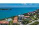 Gorgeous aerial view of complex buildings, pool, landscaping, and water views at 6158 Palma Del Mar S Blvd # 306, St Petersburg, FL 33715