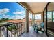Balcony with chairs offering views of nearby townhouses and blue skies at 6158 Palma Del Mar S Blvd # 306, St Petersburg, FL 33715