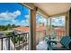 Balcony with chairs overlooking townhouses, golf course, and the water at 6158 Palma Del Mar S Blvd # 306, St Petersburg, FL 33715