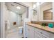 Renovated bathroom featuring marble tiling, a walk-in shower with seating, and modern vanity at 6158 Palma Del Mar S Blvd # 306, St Petersburg, FL 33715