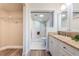 Well-lit bathroom with a walk-in shower, a vanity, and access to a closet at 6158 Palma Del Mar S Blvd # 306, St Petersburg, FL 33715