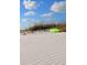Seascape of a beach with a green sled on the white sand dune in the bright sunlight at 6158 Palma Del Mar S Blvd # 306, St Petersburg, FL 33715