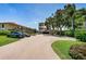 Exterior view of a multi-story building with parking and landscaping on a clear day at 6158 Palma Del Mar S Blvd # 306, St Petersburg, FL 33715