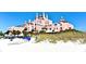 Stunning beachfront property featuring a beautiful pink exterior and lush surroundings at 6158 Palma Del Mar S Blvd # 306, St Petersburg, FL 33715
