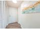 Hallway featuring a neutral paint color, luxury vinyl plank flooring, and storage at 6158 Palma Del Mar S Blvd # 306, St Petersburg, FL 33715