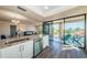 Open kitchen with stainless steel appliances, granite counters, and sliding door access to the balcony at 6158 Palma Del Mar S Blvd # 306, St Petersburg, FL 33715