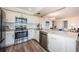 Contemporary kitchen with stainless steel appliances, granite counters, and view into the living area at 6158 Palma Del Mar S Blvd # 306, St Petersburg, FL 33715
