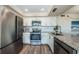 Well-equipped kitchen showcasing stainless steel appliances, ample storage, and granite countertops at 6158 Palma Del Mar S Blvd # 306, St Petersburg, FL 33715