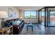 Living room with hardwood floors, a window, and sliding door access to balcony at 6158 Palma Del Mar S Blvd # 306, St Petersburg, FL 33715