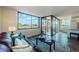Bright living room featuring hardwood floors and sliding door access to balcony at 6158 Palma Del Mar S Blvd # 306, St Petersburg, FL 33715