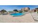 Community pool featuring a spacious deck with lounge chairs and pergolas offering shady seating areas at 6158 Palma Del Mar S Blvd # 306, St Petersburg, FL 33715