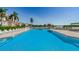 Community pool featuring lounge chairs and umbrellas on a brick pool deck at 6158 Palma Del Mar S Blvd # 306, St Petersburg, FL 33715