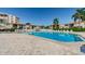 Community swimming pool with plenty of lounge chairs and lush tropical landscaping at 6158 Palma Del Mar S Blvd # 306, St Petersburg, FL 33715