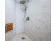 Close-up of a modern shower with marble tiling, a rain shower head, and a built-in seat at 6158 Palma Del Mar S Blvd # 306, St Petersburg, FL 33715