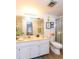 Bright bathroom featuring a vanity, toilet, and shower, complemented by wood-look flooring at 618 Bird Bay S Dr # 111, Venice, FL 34285