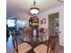 Cozy dining room featuring a glass table with seating for four and an adjacent living room area at 618 Bird Bay S Dr # 111, Venice, FL 34285