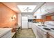 Bright kitchen featuring white appliances and cabinets, complemented by wood-look flooring and a breakfast nook at 618 Bird Bay S Dr # 111, Venice, FL 34285