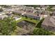 Aerial view of townhome community near a pond, showcasing the neighborhood's layout and green spaces at 6542 95Th N Pl, Pinellas Park, FL 33782