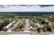 An aerial view showcases the layout of the neighborhood and surrounding tree coverage at 6542 95Th N Pl, Pinellas Park, FL 33782