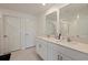 Bathroom with double sink vanity, modern mirrors, and tiled flooring at 6542 95Th N Pl, Pinellas Park, FL 33782