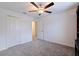 Bedroom features neutral walls, carpet, ceiling fan, and closet offering flexible space at 6542 95Th N Pl, Pinellas Park, FL 33782