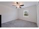 Neutral bedroom with ceiling fan and a window, offering a blank canvas for customization at 6542 95Th N Pl, Pinellas Park, FL 33782