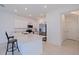 Bright kitchen featuring white cabinetry, stainless steel appliances, and a quartz countertop breakfast bar at 6542 95Th N Pl, Pinellas Park, FL 33782