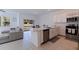 Open kitchen layout featuring a breakfast bar, stainless steel appliances, and seamless flow to the living area at 6542 95Th N Pl, Pinellas Park, FL 33782