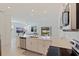 Open kitchen flows into the living area, stainless steel appliances, and white countertops at 6542 95Th N Pl, Pinellas Park, FL 33782