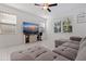 Comfortable living room with a large sectional sofa, stylish entertainment center, and plenty of natural light at 6542 95Th N Pl, Pinellas Park, FL 33782