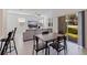 Open-concept living area with dining space, large TV, and natural light at 6542 95Th N Pl, Pinellas Park, FL 33782