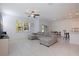 Open-concept living room with tile floors, a large sectional sofa, and access to the backyard at 6542 95Th N Pl, Pinellas Park, FL 33782