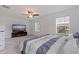 Bright bedroom with large windows, ceiling fan, and entertainment center at 6542 95Th N Pl, Pinellas Park, FL 33782