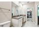 Spacious bathroom showcasing double sinks, and convenient access to a walk-in closet at 6745 Citrus Creek Ln, Tampa, FL 33625