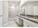 Bright bathroom with double sinks, granite countertops, and a sleek glass-enclosed shower at 6745 Citrus Creek Ln, Tampa, FL 33625