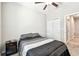 This bedroom features a bed, ceiling fan, night stand and closet with bi-fold doors at 6745 Citrus Creek Ln, Tampa, FL 33625