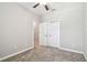 Neutral bedroom features plush carpeting, ceiling fan, and closet with bi-fold doors at 6745 Citrus Creek Ln, Tampa, FL 33625