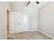 Bedroom with carpet, white walls and baseboards, white double doors, ceiling fan at 6745 Citrus Creek Ln, Tampa, FL 33625