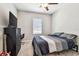 This bedroom features a bed, dresser, desk, a guitar, and a ceiling fan at 6745 Citrus Creek Ln, Tampa, FL 33625