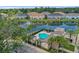 Upscale community pool with palm trees, lounge seating, and a covered pavilion, set against a tranquil pond backdrop at 6745 Citrus Creek Ln, Tampa, FL 33625