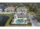 Charming community pool area featuring comfortable lounge chairs, a shaded pavilion, and easy access to the adjacent pond at 6745 Citrus Creek Ln, Tampa, FL 33625