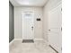 Bright entryway with tile floors, a white door and neutral wall colors at 6745 Citrus Creek Ln, Tampa, FL 33625