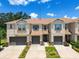 External view of the townhome displaying its 2-car garage, well-kept landscaping, and a welcoming entrance at 6745 Citrus Creek Ln, Tampa, FL 33625