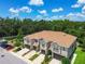 Attractive townhome featuring a welcoming facade, attached garages, and lush landscaping in a well-maintained community at 6745 Citrus Creek Ln, Tampa, FL 33625