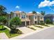 View of the property showcasing its two-story exterior, attached garages, and landscaped front yard at 6745 Citrus Creek Ln, Tampa, FL 33625