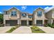 Inviting townhomes with stylish design, blue shutters, and well-kept landscaping at 6745 Citrus Creek Ln, Tampa, FL 33625